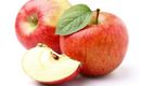 Two red apples and a sliced apple with a green leaf. The apples are fresh and juicy.