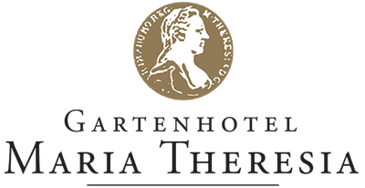 Un logo elegante con una medaglia dorata e un ritratto stilizzato. Sotto c'è il nome del marchio in carattere chiaro.