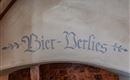 A decorative sign with the inscription "Beer Dungeon". It is located on a wall and conveys a rustic atmosphere.