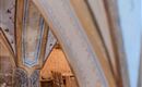 A historic room with gently arched curves and decorative details. The warm lighting creates an inviting atmosphere.
