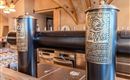 An elegant beer outlet with ornate taps. The wooden counter and rustic style give the location a cozy atmosphere.